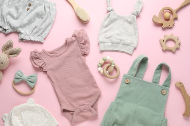 Photo of Baby clothes and accessories on pink background, flat lay