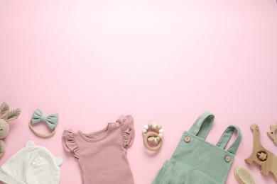 Photo of Baby clothes and accessories on pink background, flat lay. Space for text