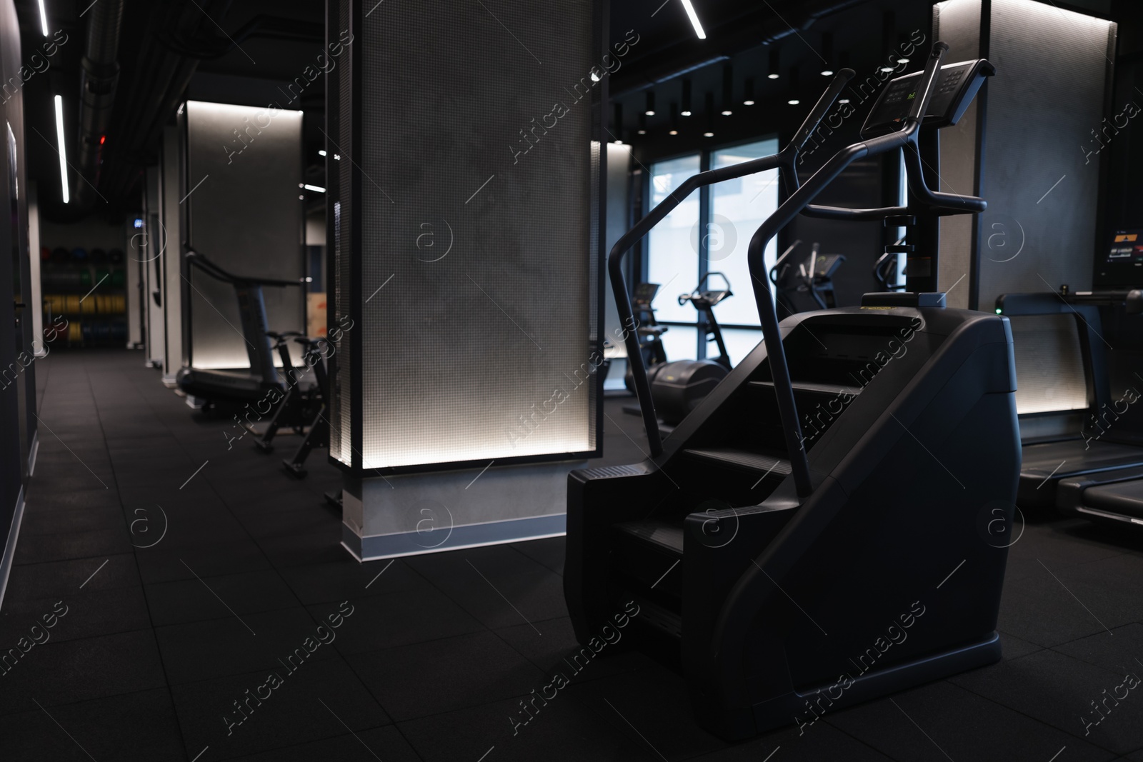 Professional stair climber machine in gym, space for text Photo of Professional stair climber machine in gym, space for text