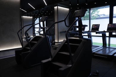 Photo of Professional stair climber machines in gym. Healthy lifestyle