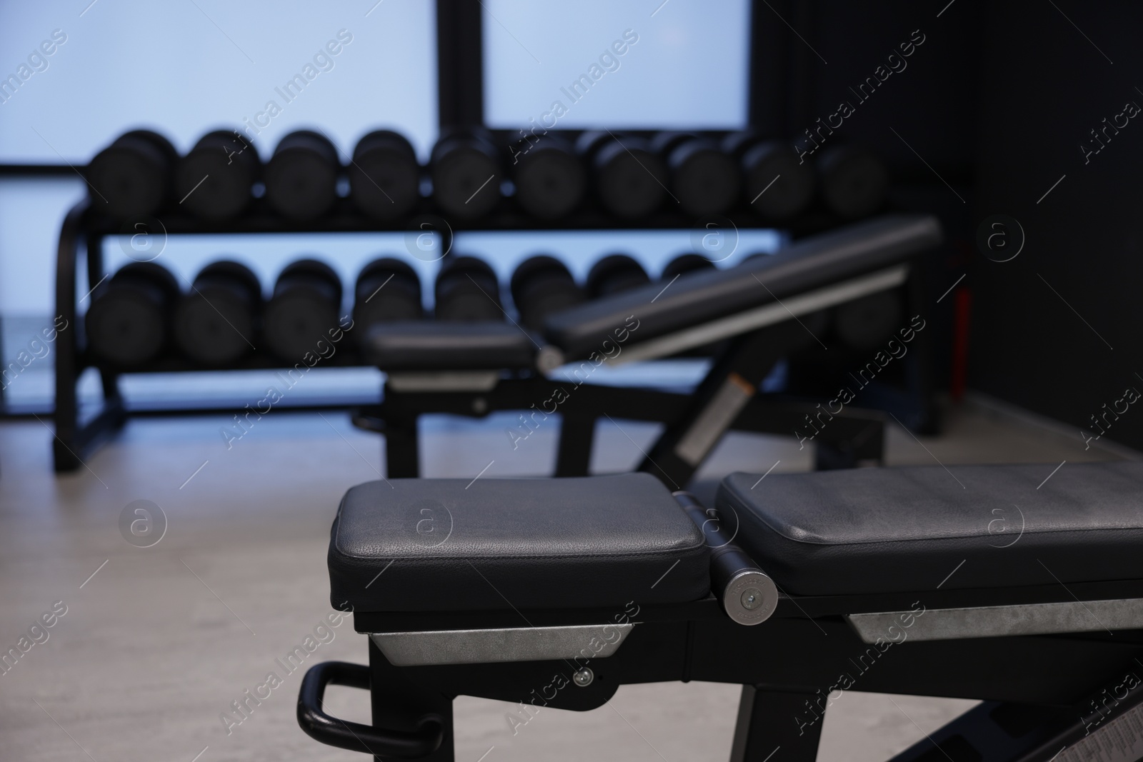 Photo of Dumbbells and other equipment in gym, closeup
