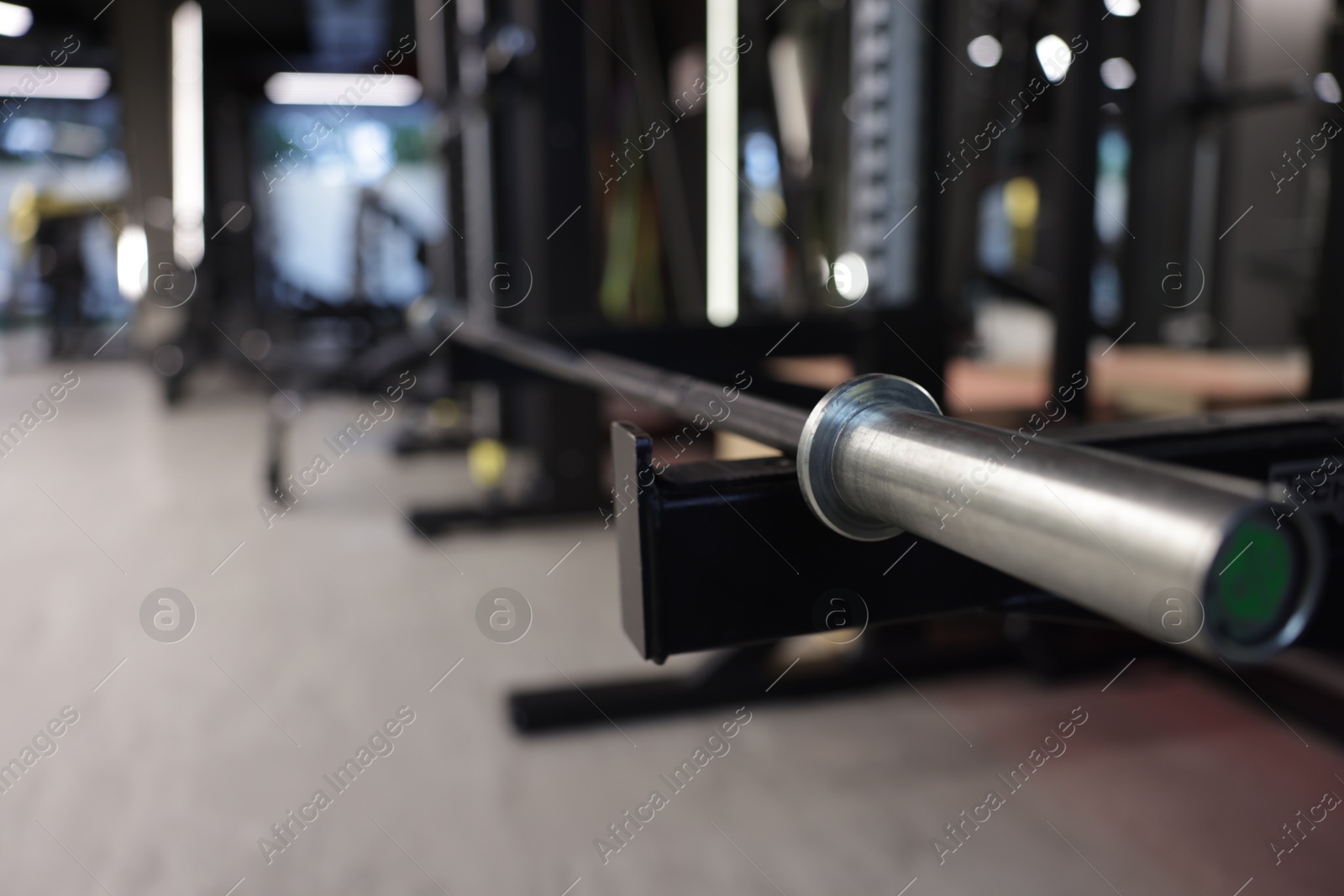 Professional barbell and other equipment in gym, closeup. Space for text Photo of Professional barbell and other equipment in gym, closeup. Space for text