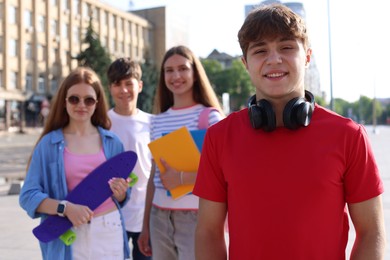 Photo of Group of teenagers walking together on city street