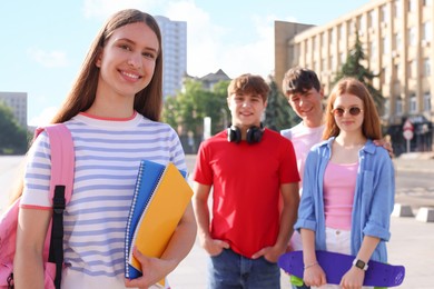 Photo of Group of teenagers walking together on city street