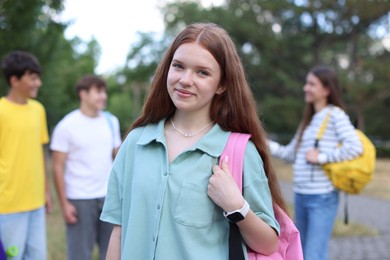 Photo of Portrait of teenager with backpack outdoors, selective focus