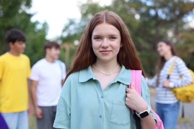 Photo of Portrait of teenager with backpack outdoors, selective focus
