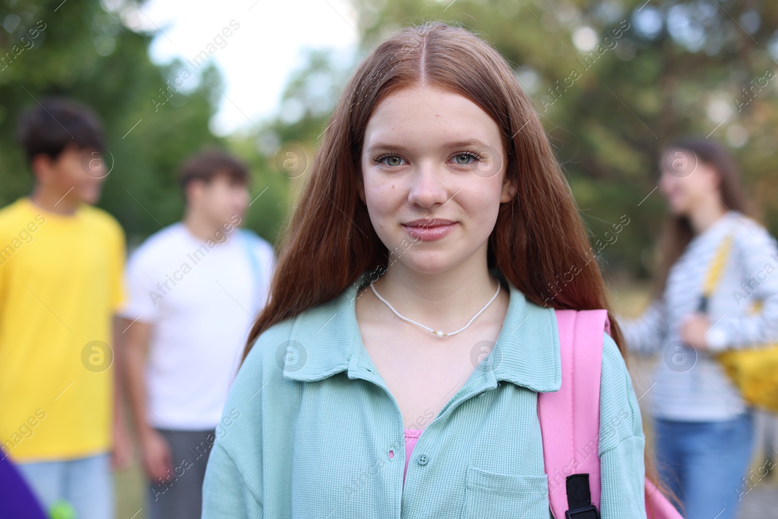Portrait of teenager with backpack outdoors, selective focus Photo of Portrait of teenager with backpack outdoors, selective focus