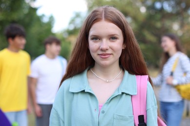 Photo of Portrait of teenager with backpack outdoors, selective focus