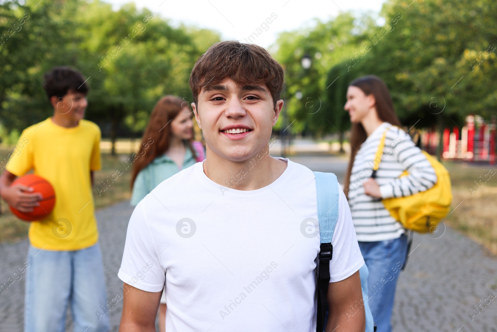 Portrait of teenager with backpack outdoors, selective focus Photo of Portrait of teenager with backpack outdoors, selective focus