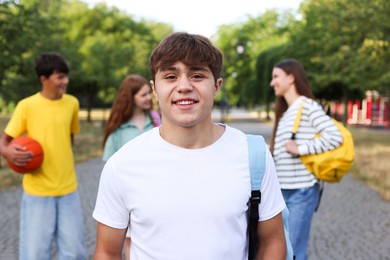 Photo of Portrait of teenager with backpack outdoors, selective focus
