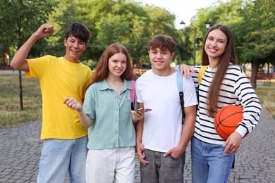 Photo of Group of teenagers walking together in park