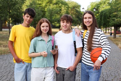 Photo of Group of teenagers walking together in park