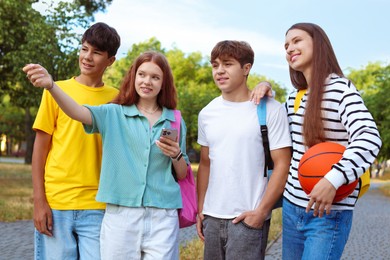 Photo of Group of teenagers walking together in park