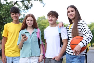 Photo of Group of teenagers walking together in park