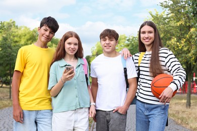 Photo of Group of teenagers walking together in park