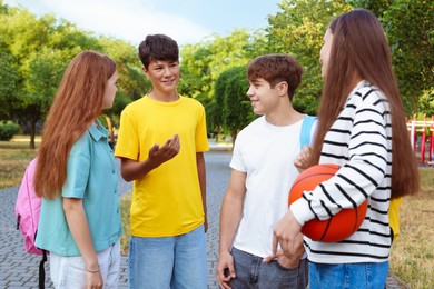 Photo of Group of teenagers spending time together in park