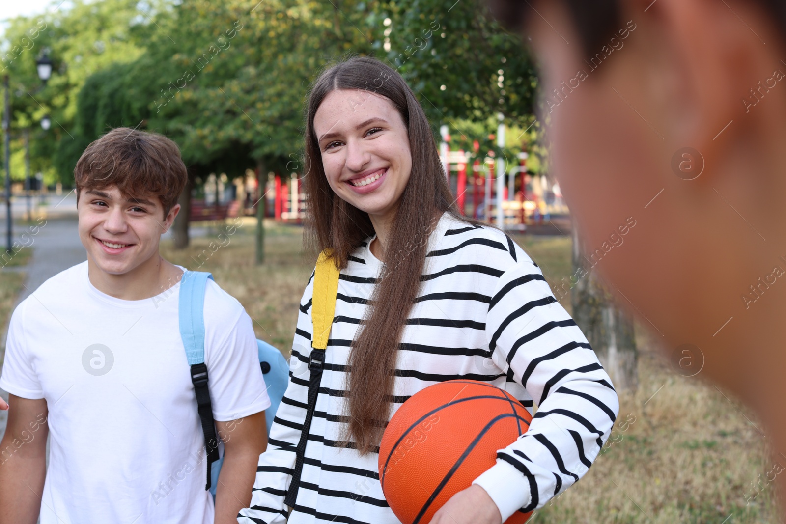 Group of teenagers spending time together in park Photo of Group of teenagers spending time together in park