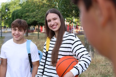 Photo of Group of teenagers spending time together in park