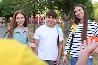 Photo of Group of teenagers spending time together in park