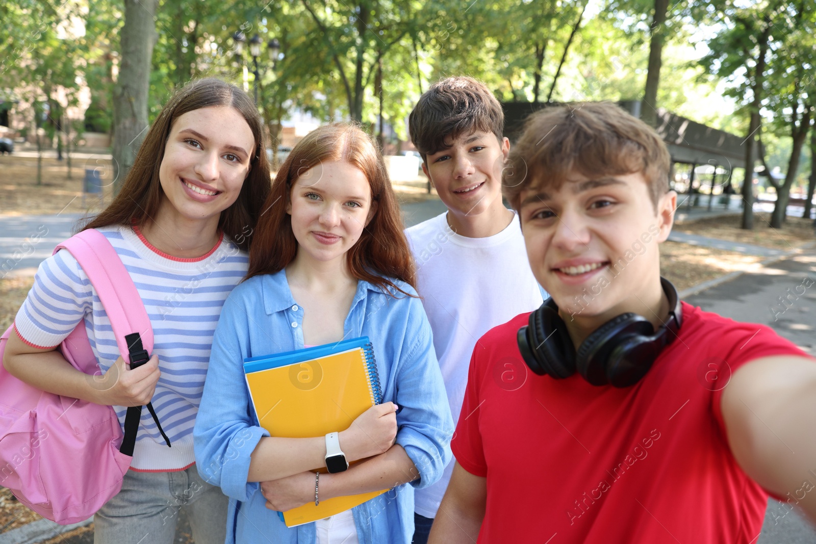 Group of teenagers taking selfie in park Photo of Group of teenagers taking selfie in park