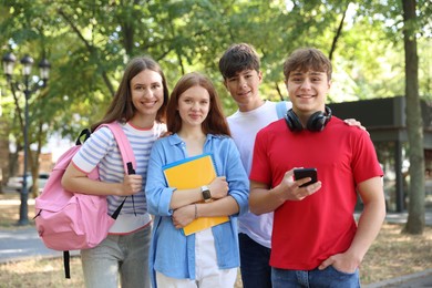 Photo of Group of teenagers walking together in park