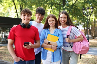 Photo of Group of teenagers walking together in park