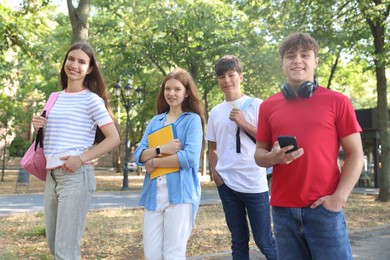 Photo of Group of teenagers walking together in park
