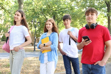 Photo of Group of teenagers walking together in park