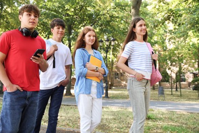 Photo of Group of teenagers walking together in park