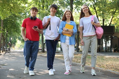 Photo of Group of teenagers walking together in park