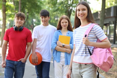 Photo of Group of teenagers walking together in park