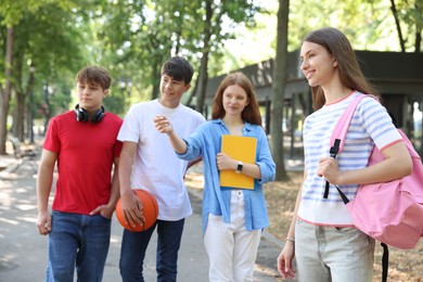 Photo of Group of teenagers walking together in park
