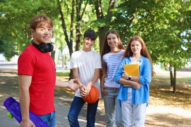 Photo of Group of teenagers walking together in park