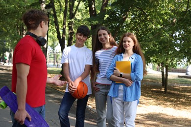 Photo of Group of teenagers walking together in park