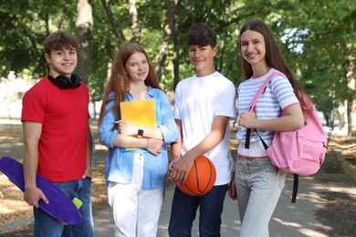 Photo of Group of teenagers walking together in park