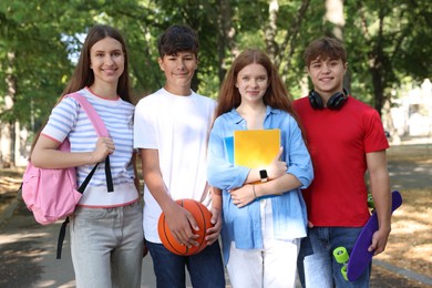 Photo of Group of teenagers walking together in park