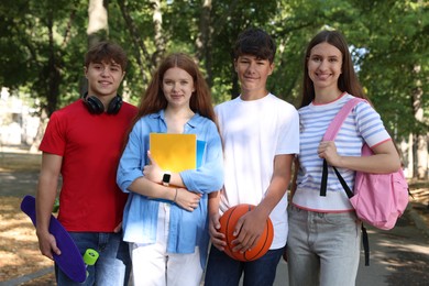 Photo of Group of teenagers walking together in park