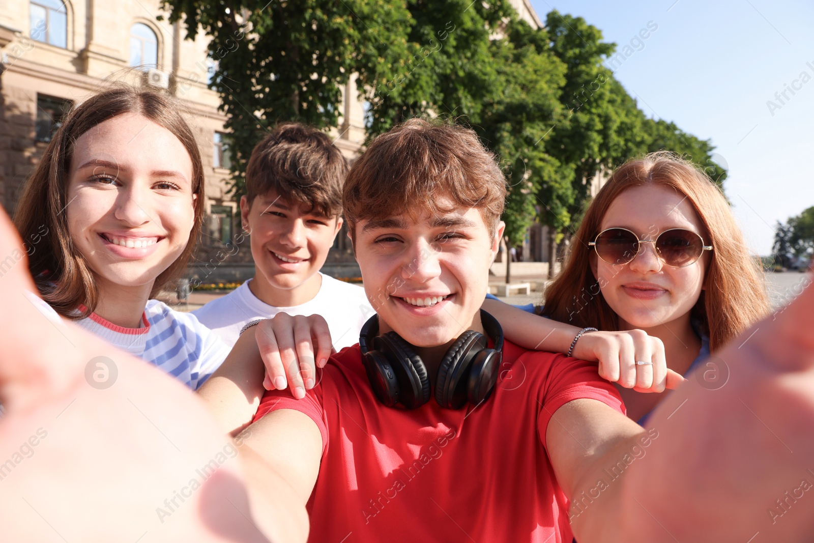Group of teenagers taking selfie on city street Photo of Group of teenagers taking selfie on city street