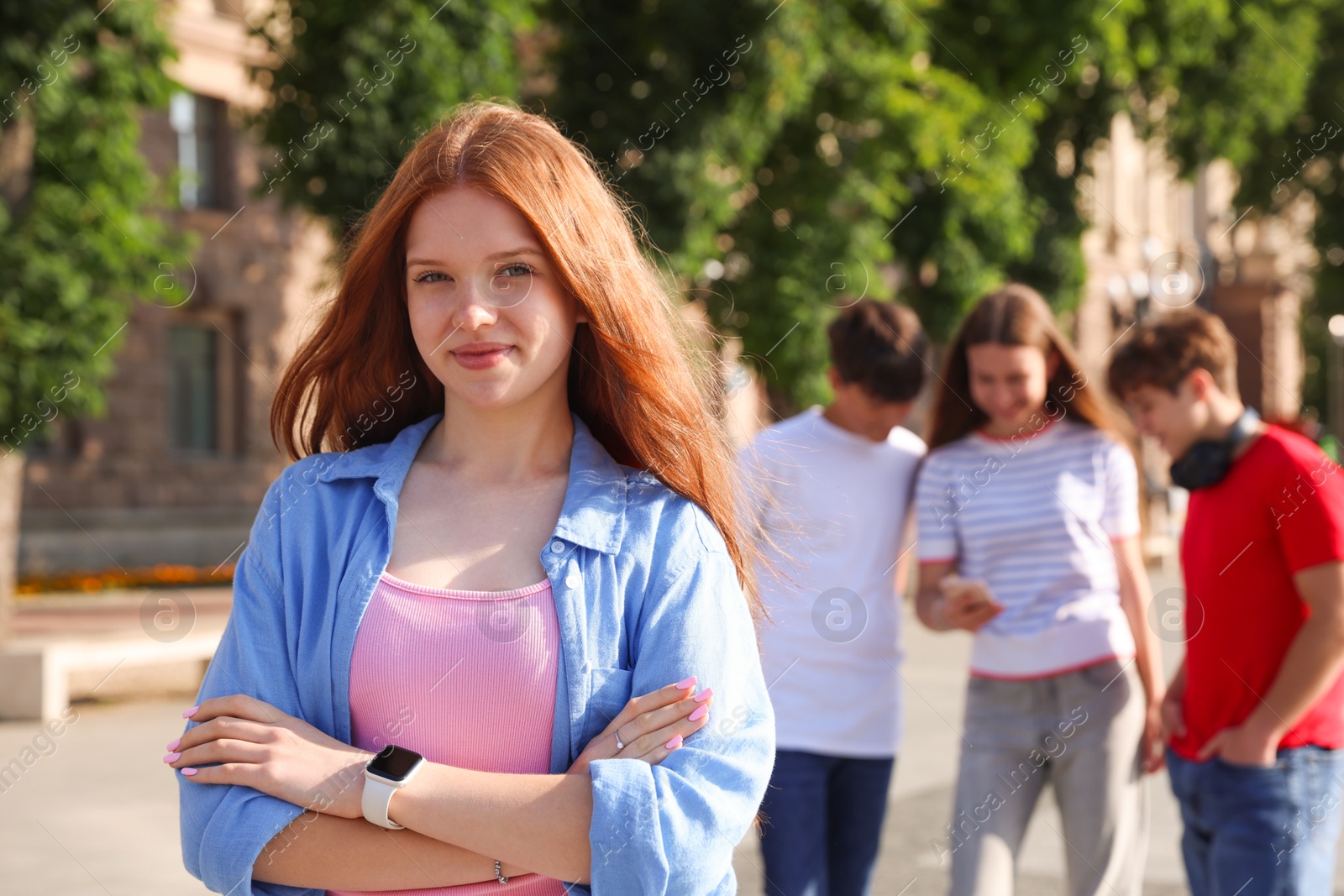Portrait of teenage girl on city street, selective focus Photo of Portrait of teenage girl on city street, selective focus