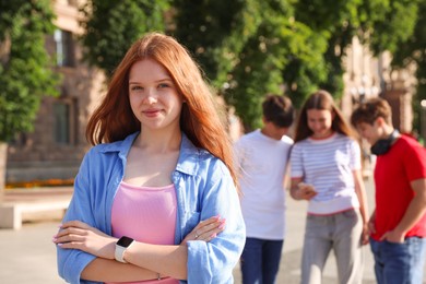 Photo of Portrait of teenage girl on city street, selective focus