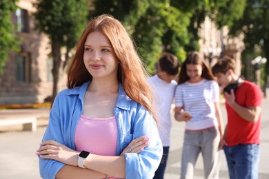 Photo of Portrait of teenage girl on city street, selective focus