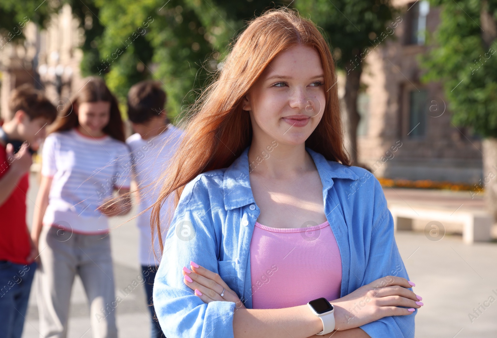 Portrait of teenage girl on city street, selective focus Photo of Portrait of teenage girl on city street, selective focus