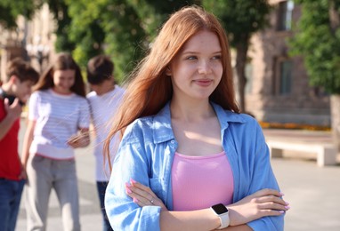 Photo of Portrait of teenage girl on city street, selective focus