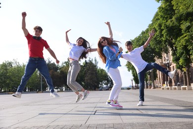 Photo of Group of teenagers having fun together on city street