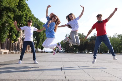 Photo of Group of teenagers having fun together on city street