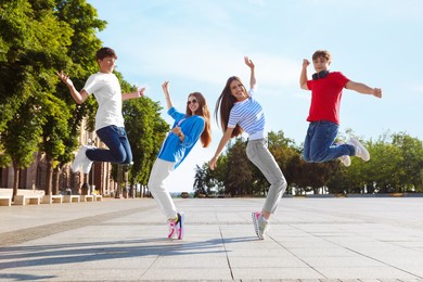 Photo of Group of teenagers having fun together on city street