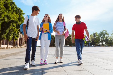 Photo of Group of teenagers walking together on city street