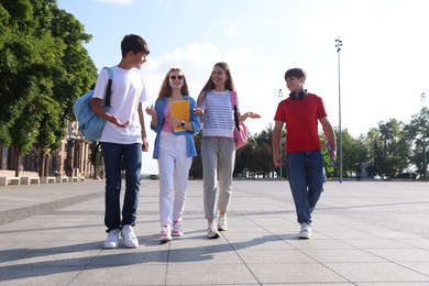 Photo of Group of teenagers walking together on city street