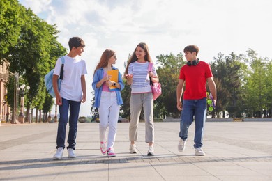 Photo of Group of teenagers walking together on city street