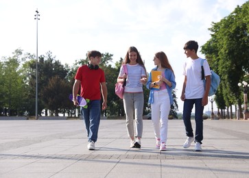 Photo of Group of teenagers walking together on city street